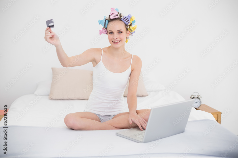 Relaxed natural brown haired woman in hair curlers shopping onli Relaxed natural brown haired woman in hair curlers shopping onli