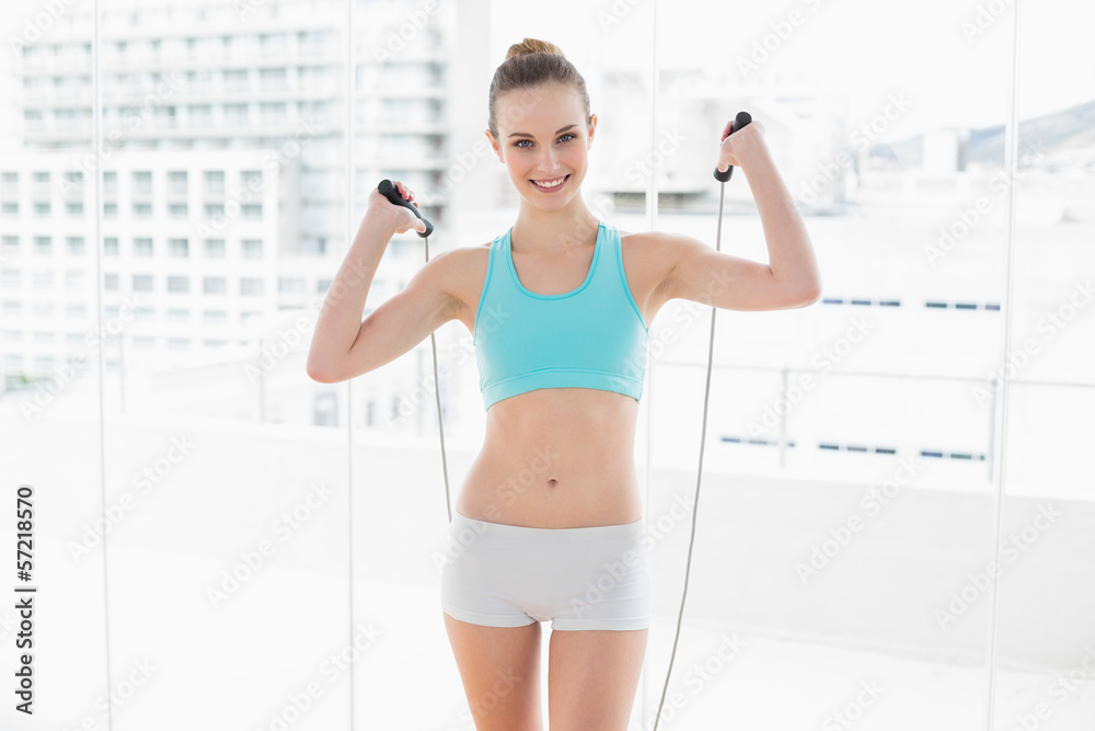 Sporty content woman exercising with skipping rope Sporty content woman exercising with skipping rope