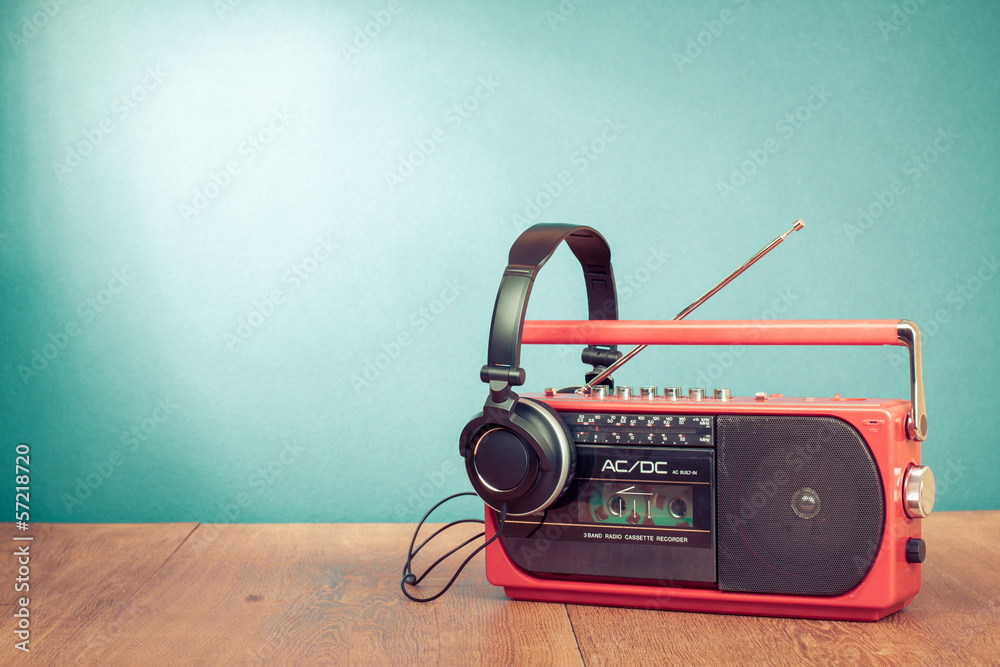 Retro cassette player and phones in front mint green background