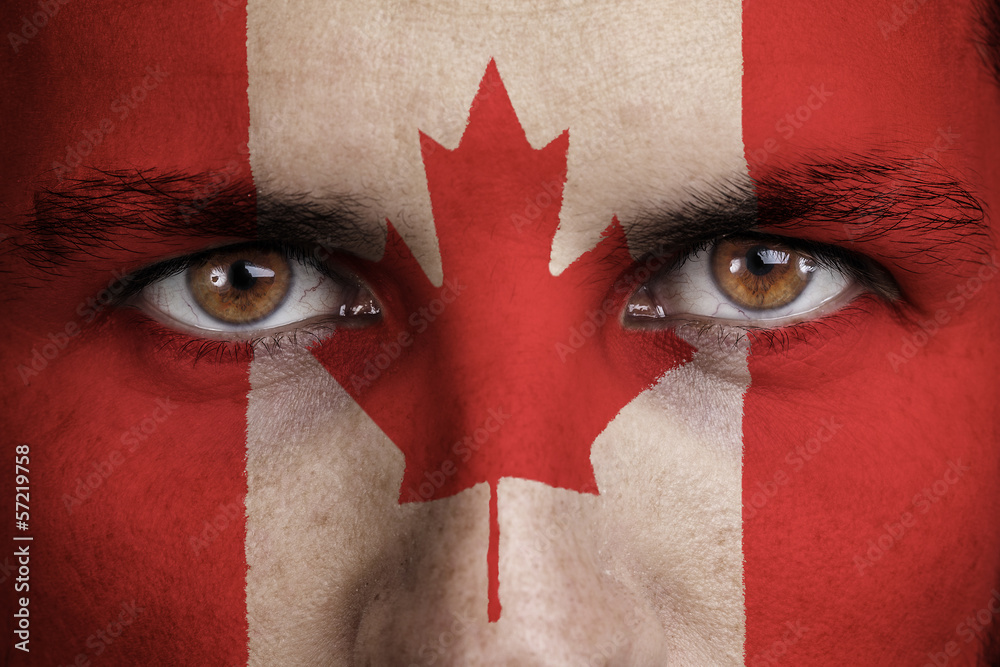Fototapeta premium canada, canadian flag painted on the face of young man