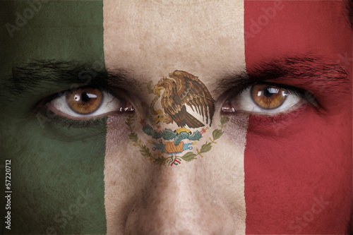 mexico, maxican flag painted on the face of young man photo