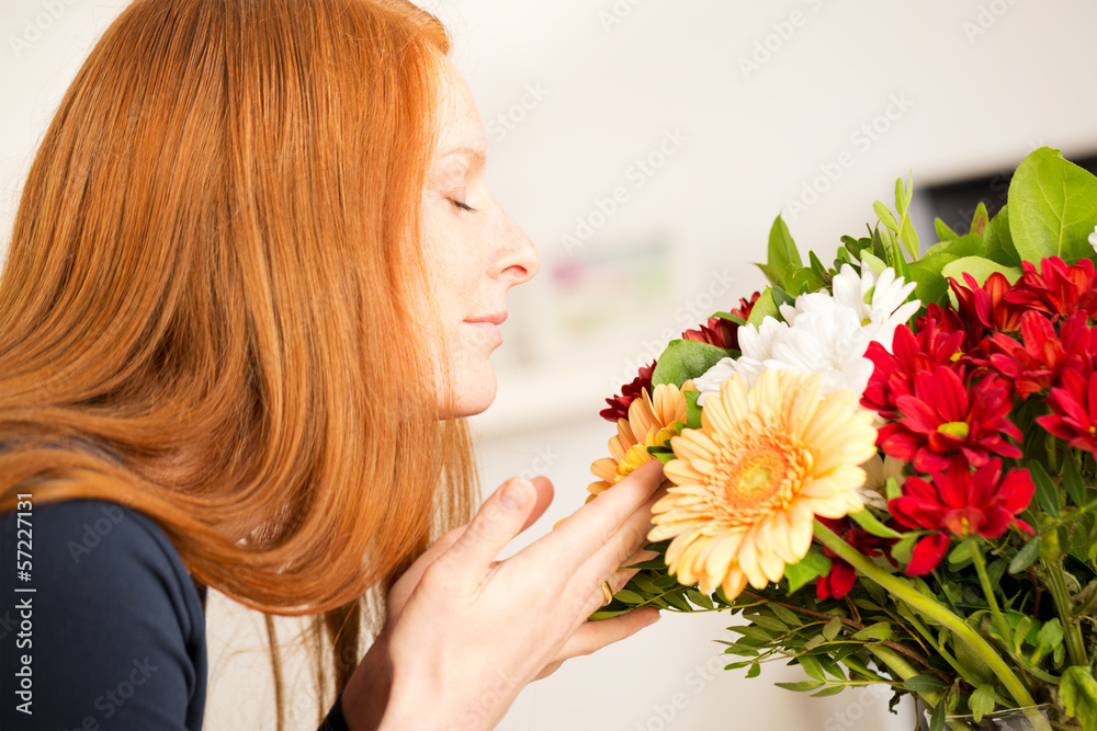 Naklejka premium Woman Smelling Flowers - Side View