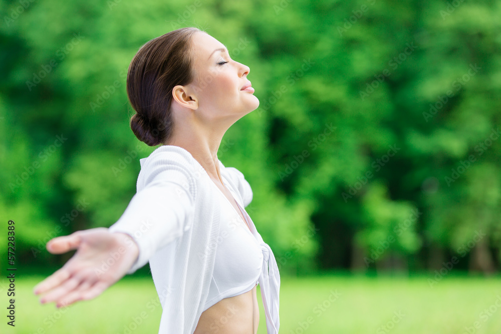 Profile of sportive woman with outstretched arms and closed eyes Profile of sportive woman with outstretched arms and closed eyes