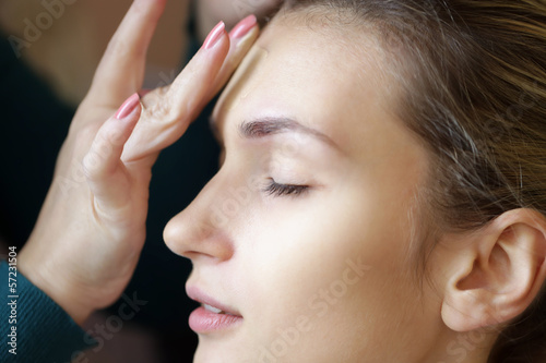 applying foundation on face for make-up, backstage