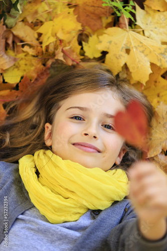 Autumn fun - lovely girl has a fun in autumn park