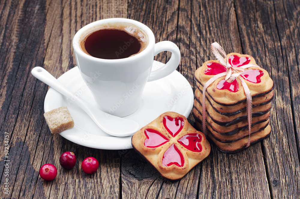 Cup of hot coffee and cookies tied ribbon