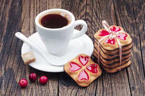Cup of hot coffee and cookies tied ribbon