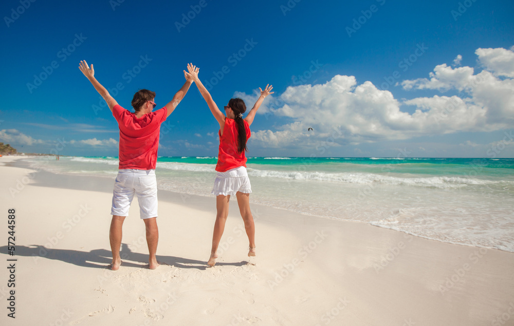 Rear view of Young couple enjoying each other on a tropical Rear view of Young couple enjoying each other on a tropical