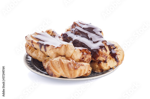 Eclairs with cream in chocolate coating isolated on white