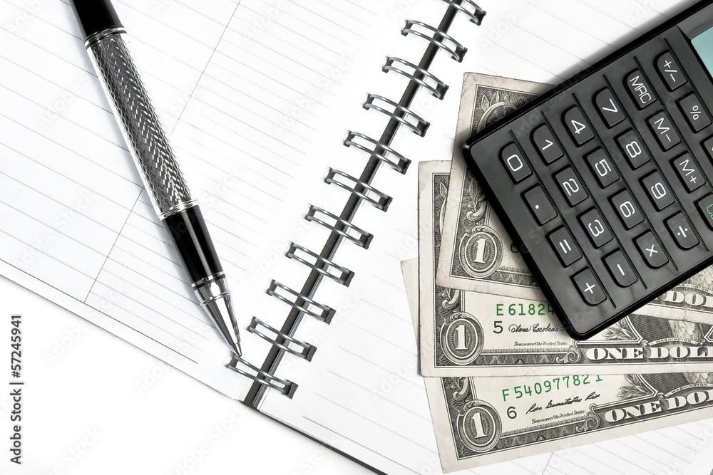 calculator, dollars and business pen on notebook calculator, dollars and business pen on notebook
