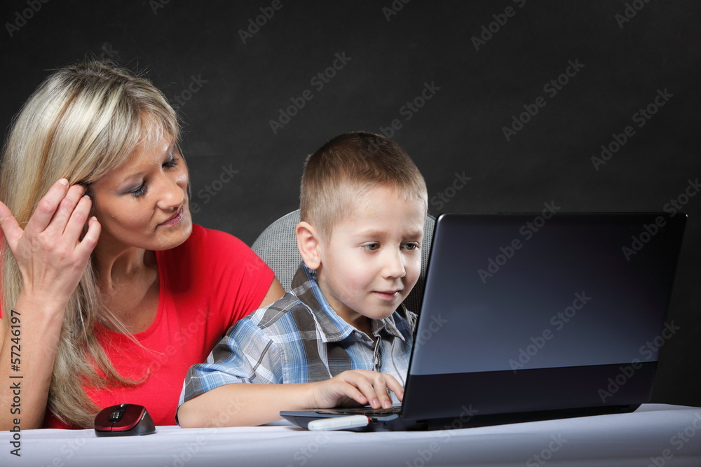 mother with son looking on the laptop mother with son looking on the laptop