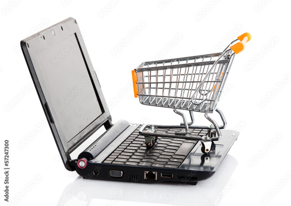 Online shopping. Shopping cart with notebook on the white. shopp
