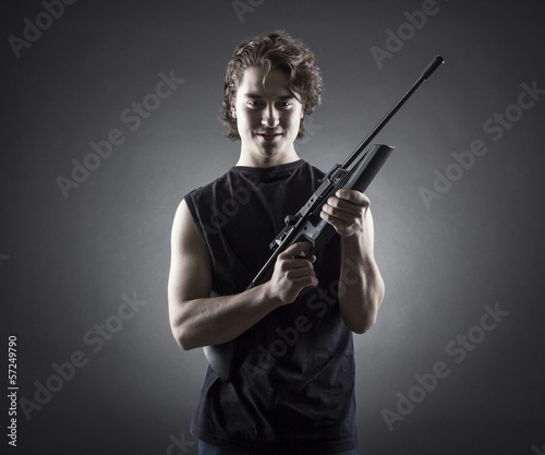 Militant young man with a gun.