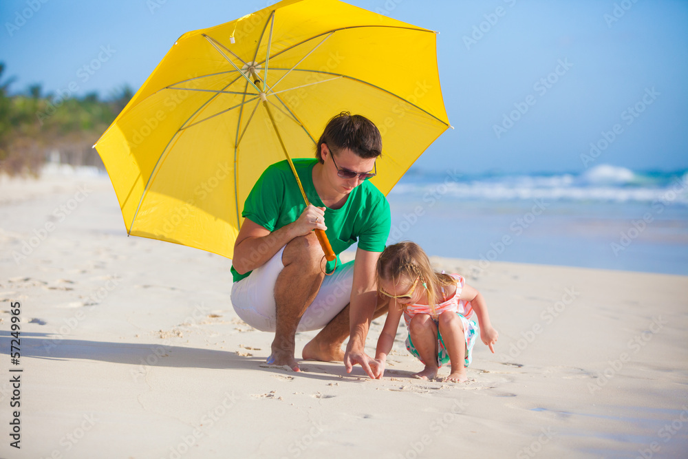 Young father and his adorable little daughter hiding from the