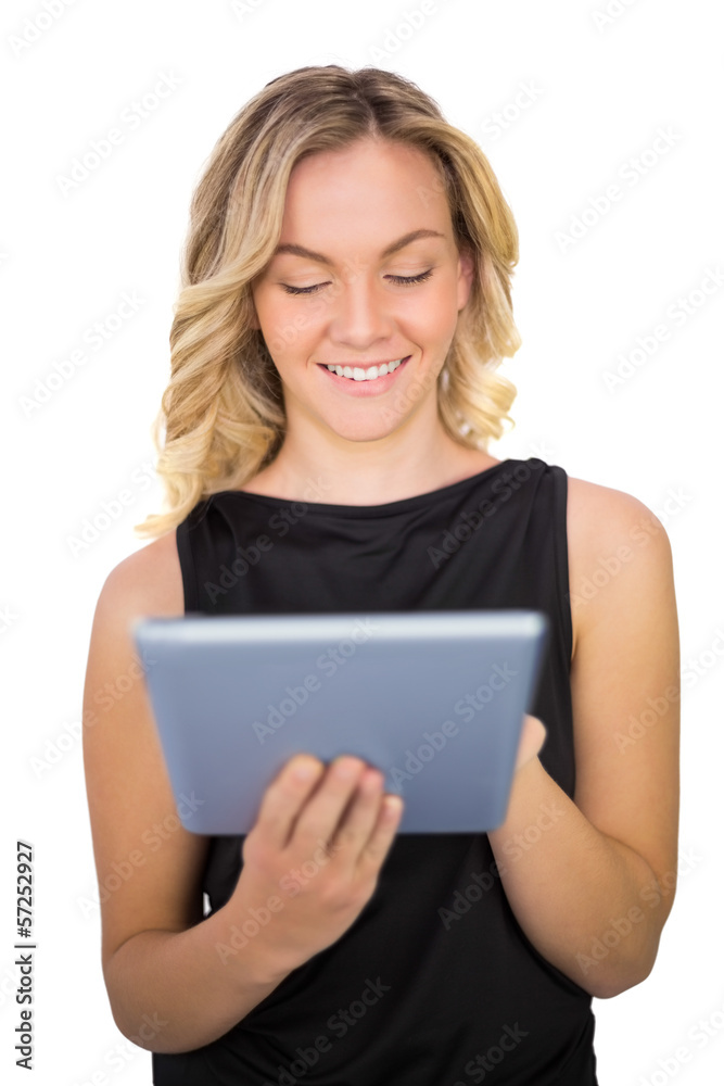 Smiling gorgeous blonde in black dress using tablet Smiling gorgeous blonde in black dress using tablet
