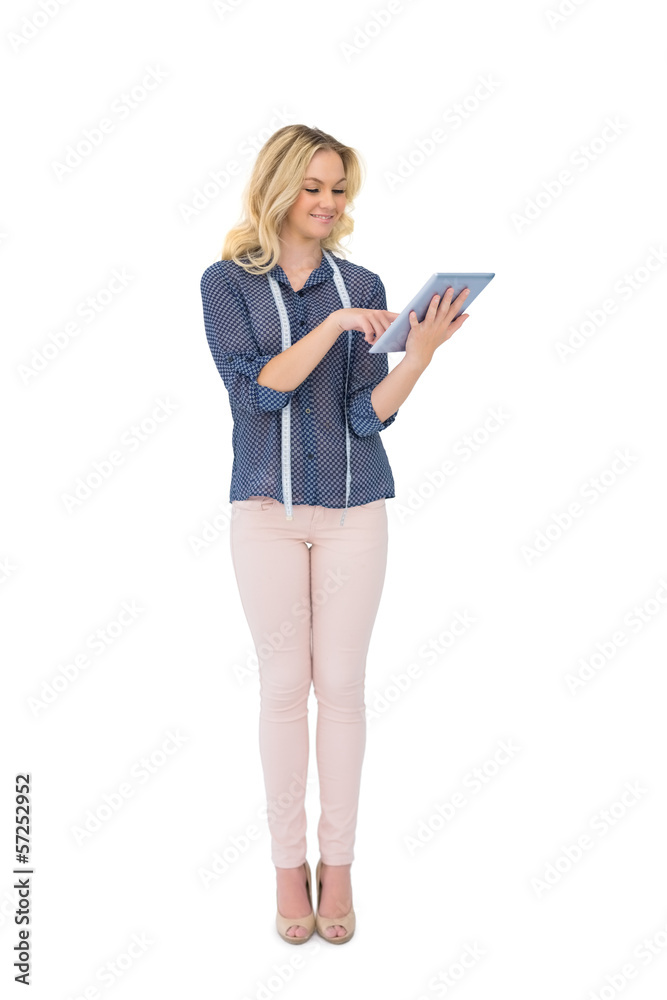 Cheerful pretty fashion designer using tablet Cheerful pretty fashion designer using tablet