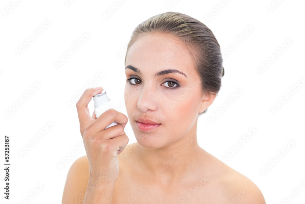 Young brunette woman holding an inhaler Young brunette woman holding an inhaler