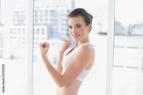 Free Download Dynamic fit brown haired model in sportswear showing her muscles - GFXLoad