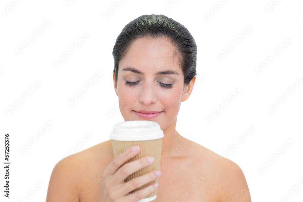 Smiling bare brunette smelling disposable cup Smiling bare brunette smelling disposable cup