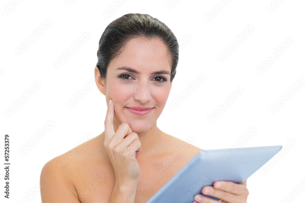 Pensive bare brunette using tablet Pensive bare brunette using tablet