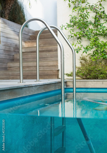 Metal ladder in a swimming pool © lightwavemedia