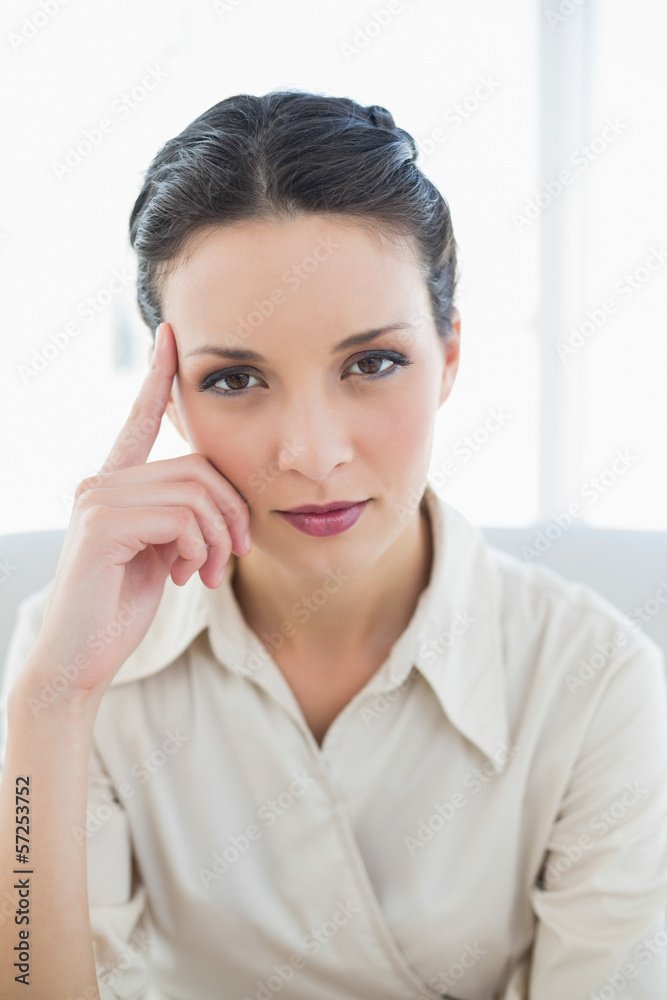 Thinking stylish brunette businesswoman posing looking at camera Thinking stylish brunette businesswoman posing looking at camera