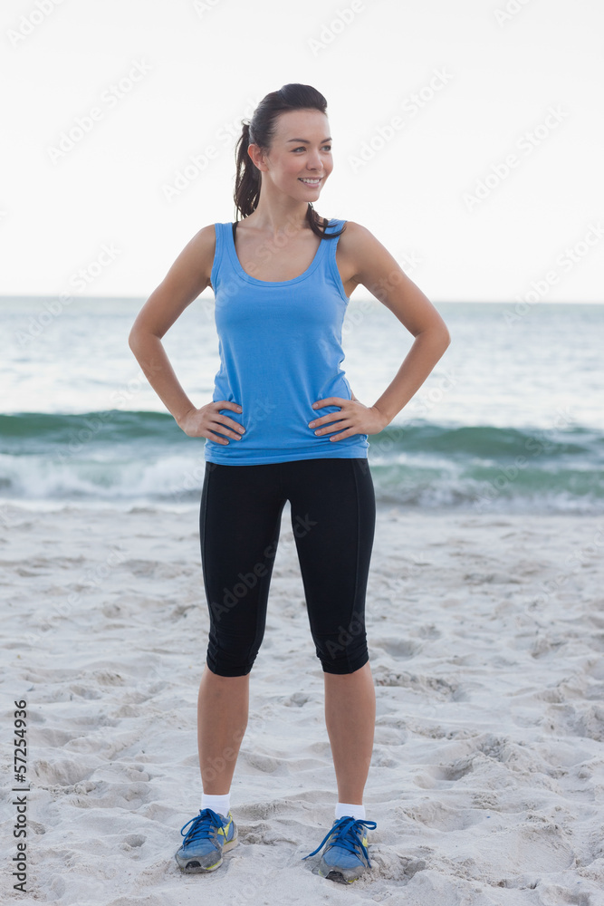 Brunette woman wearing sport wear in front of ocean Brunette woman wearing sport wear in front of ocean
