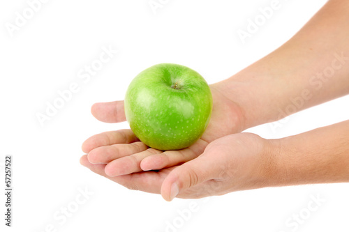 Green apple on hands.