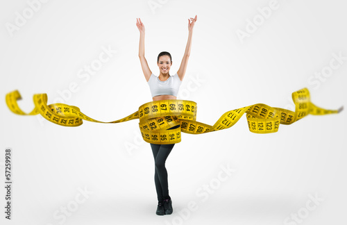 Fit young woman with a large measuring tape