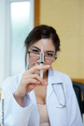 Medical doctor woman holding syringe