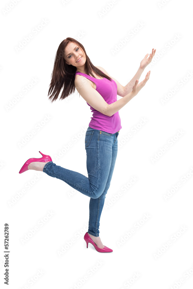 Cheerful stylish brunette wearing high shoes posing