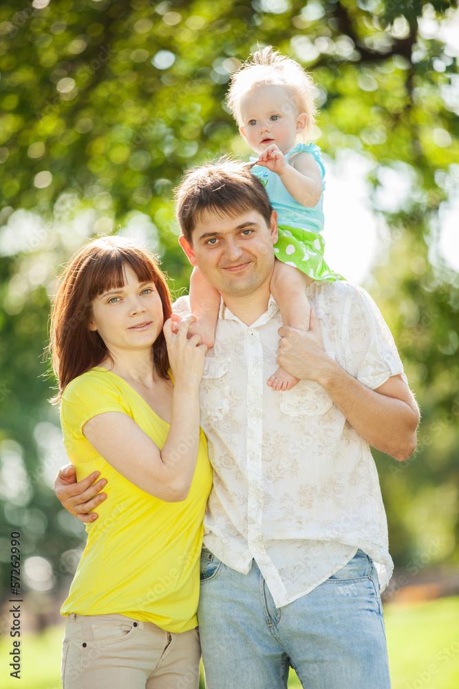 Happy mother, father and daughter in the park