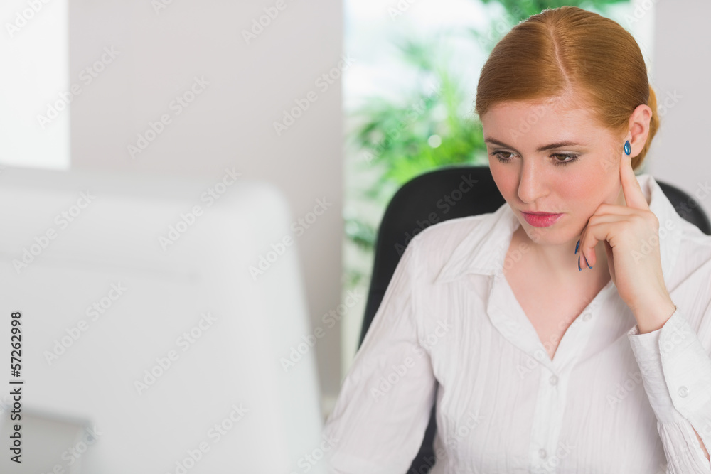 Serious businesswoman working at her desk Serious businesswoman working at her desk