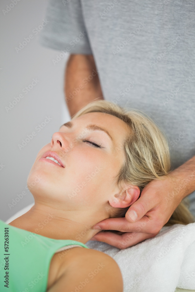 Physiotherapist holding patients head