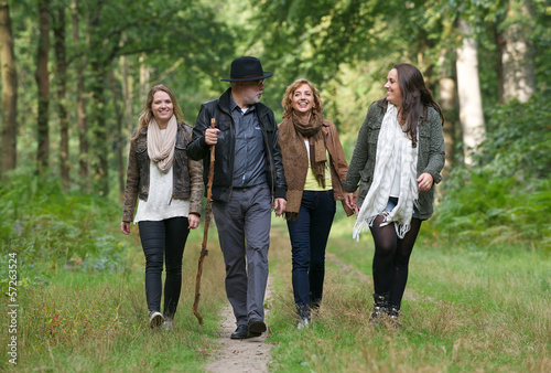 Happy family enjoying a stroll through the woods