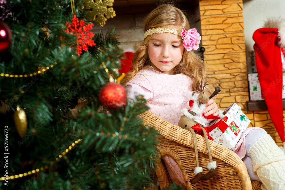 Beautiful toddler european girl with long blond curly hair sitti Beautiful toddler european girl with long blond curly hair sitti