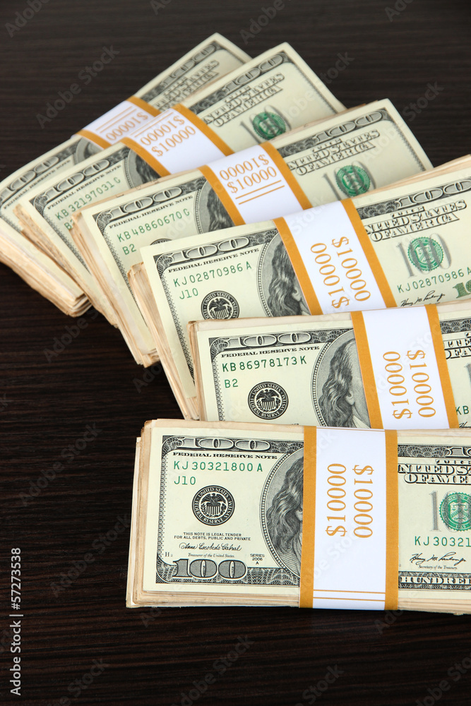 Stacks of money on wooden table Stacks of money on wooden table