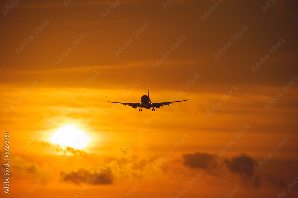 Silhouette of the big plane on a sunset background