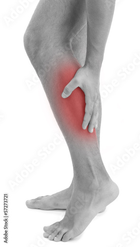Young man with leg pain, isolated on white © Africa Studio
