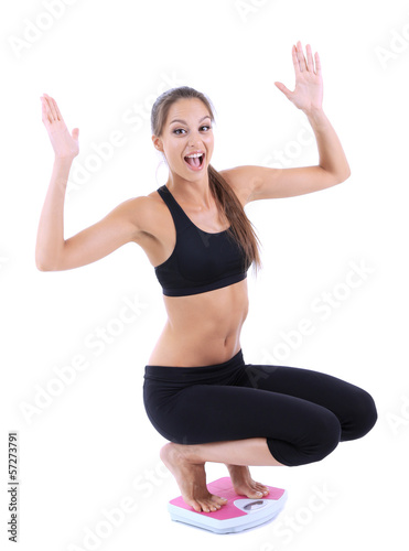 Slim young girl on scales i...