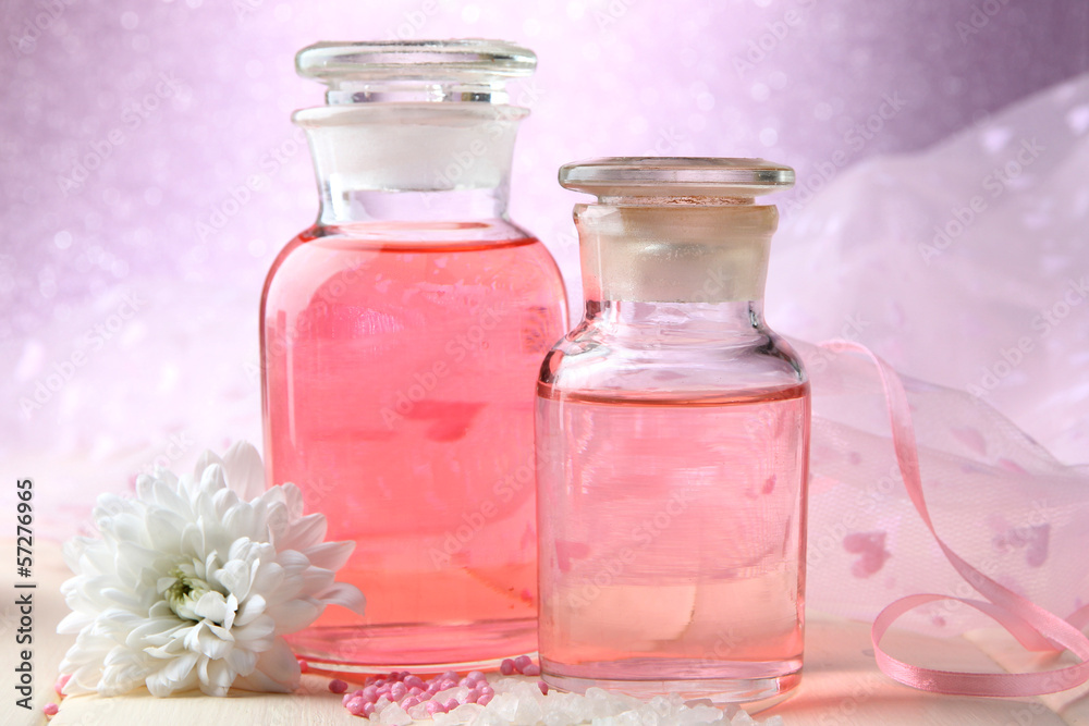 Glass bottles with color essence, on pink background Glass bottles with color essence, on pink background