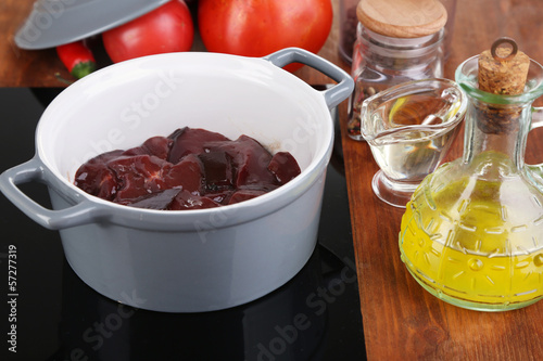 Raw liver in pan on cooking surface close-up