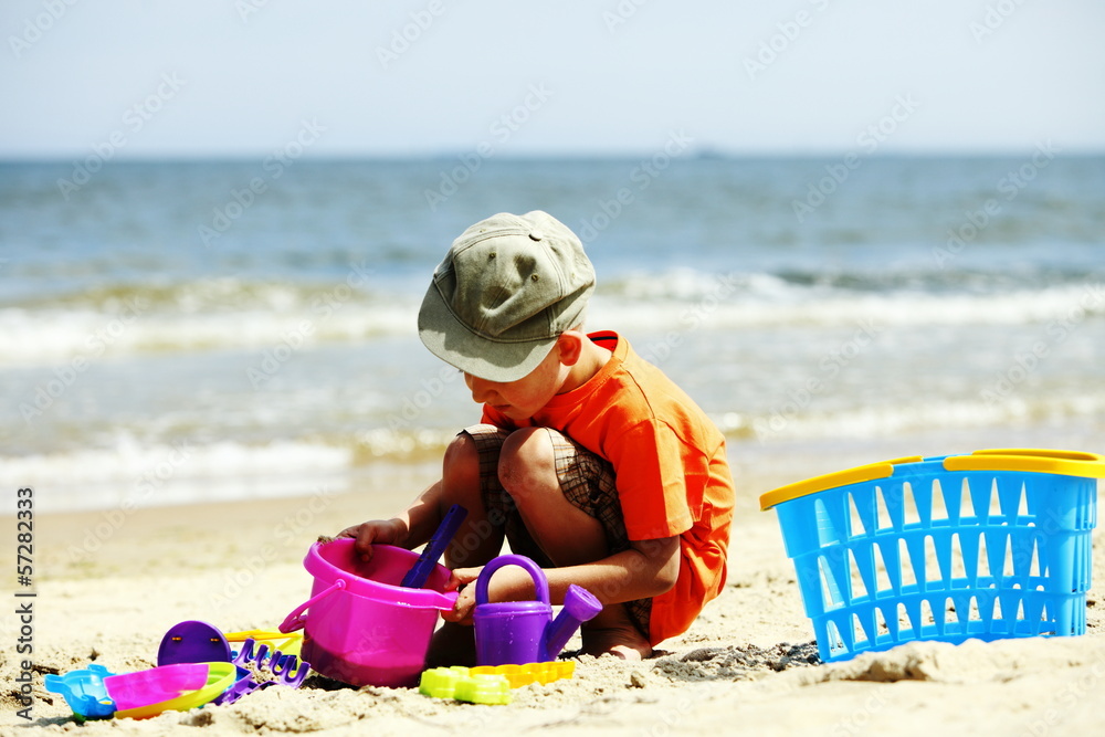 boy playing toys on beach boy playing toys on beach