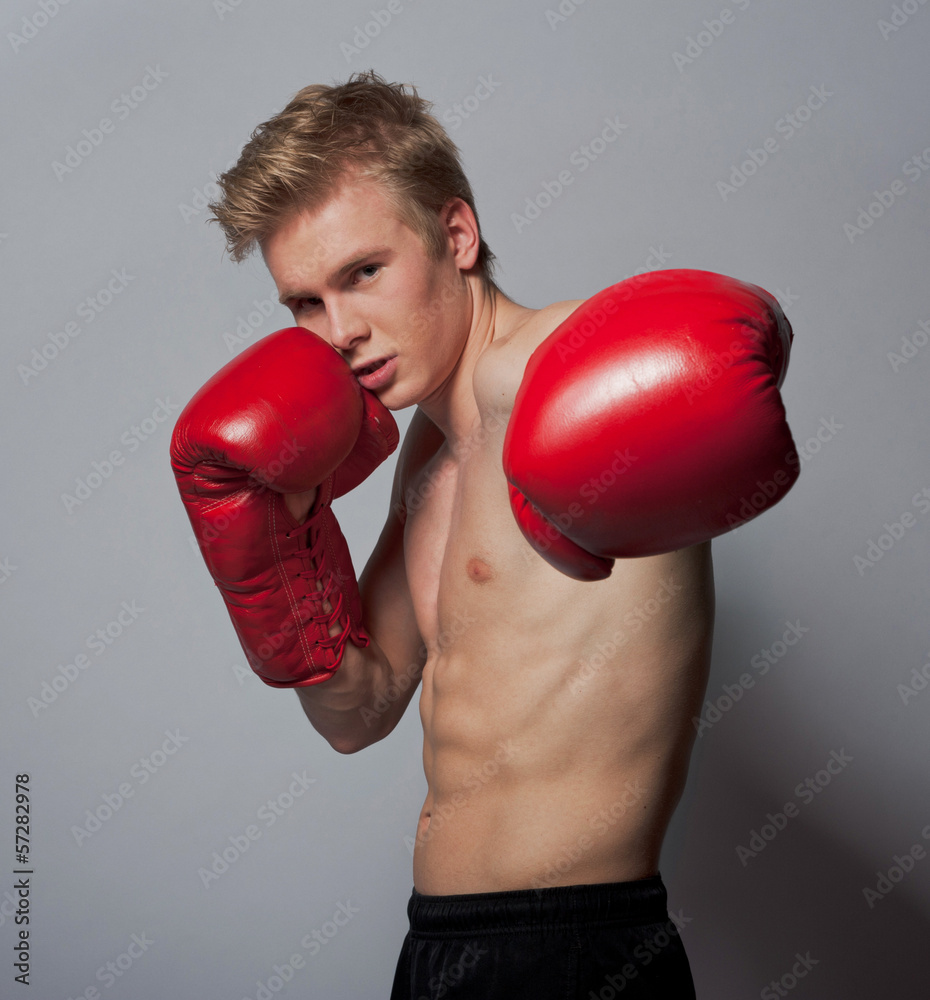 Young blond man with boxing gloves Young blond man with boxing gloves