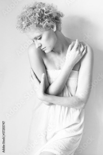 Young scrawny sexy girl, black and white in studio.