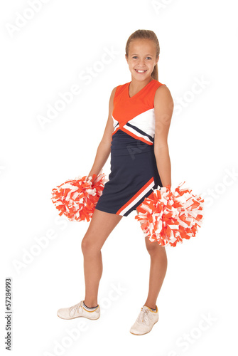 Young high school cheerleader standing with hands at her side  p