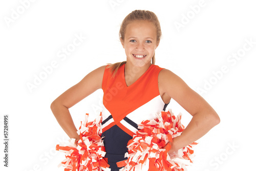Young high school cheerleader with pom poms from waist up