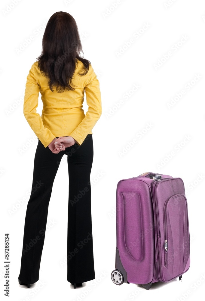 traveling young woman with suitcas in yellow suit looking at w traveling young woman with suitcas in yellow suit looking at w