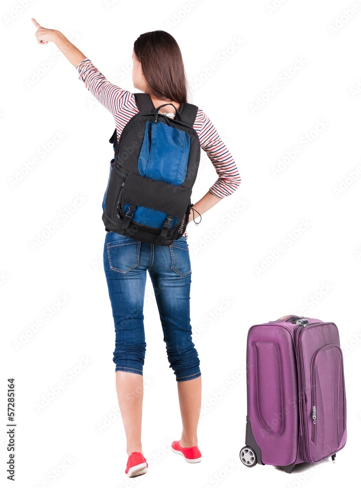 Back view of  pointing woman with backpack looking up.
