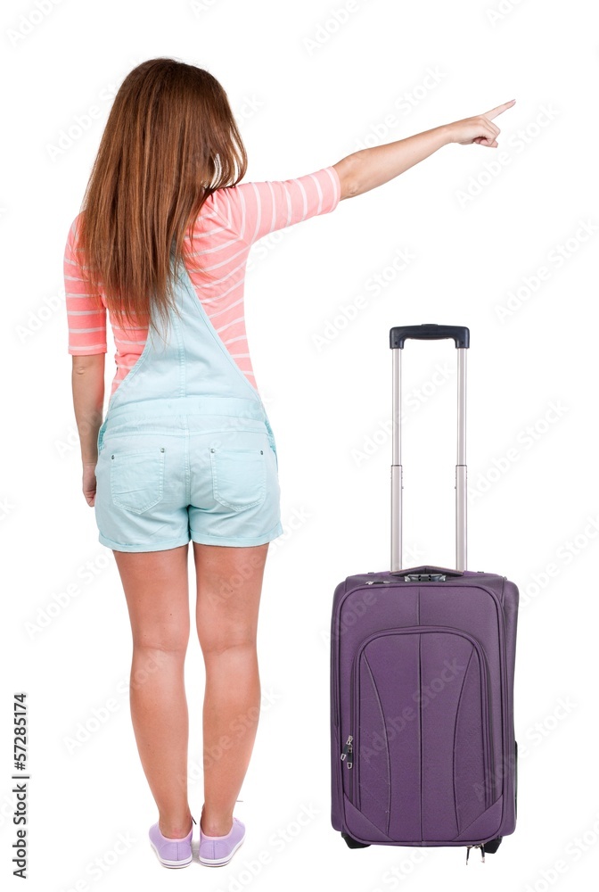Back view of traveling pointing woman with suitcase Back view of traveling pointing woman with suitcase